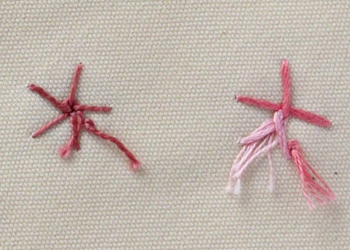 Gewebte Spinnenradstichblumen aus rosa Perlbaumwolle und buntem Garn, Rückseite