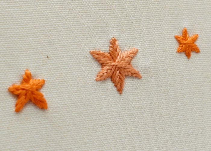 Woven Star Stitch - gefüllte Sterne sticken mit orangefarbenem Garn