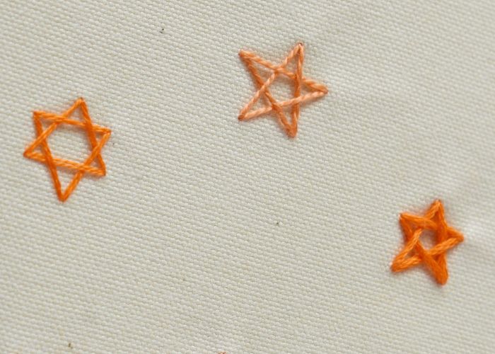 Umrissene Sterne - Woven Star Stitch mit orangefarbener Zahnseide